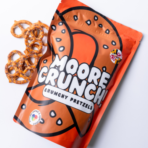 A package of Moore Crunchy Pretzels with several pretzels displayed in front of the bag.